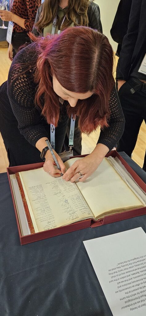 A new RES Fellow signing the Obligations Book