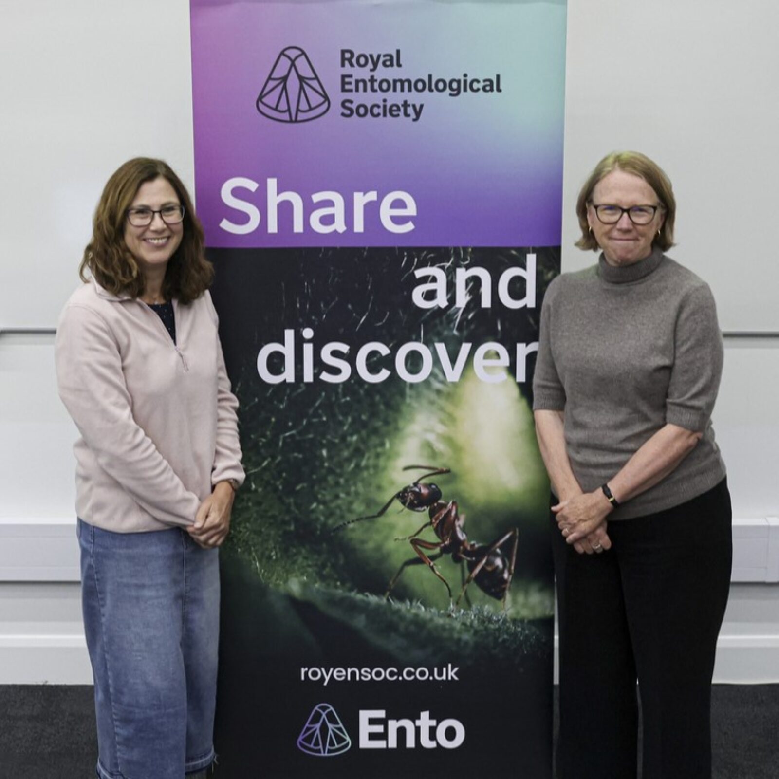 Jane Stout and Jane Hill stood at a RES branded 'Share and Discover' banner at Ento24