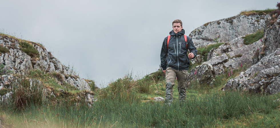 Paramo marketing - Man walking through a field in Paramo clothing